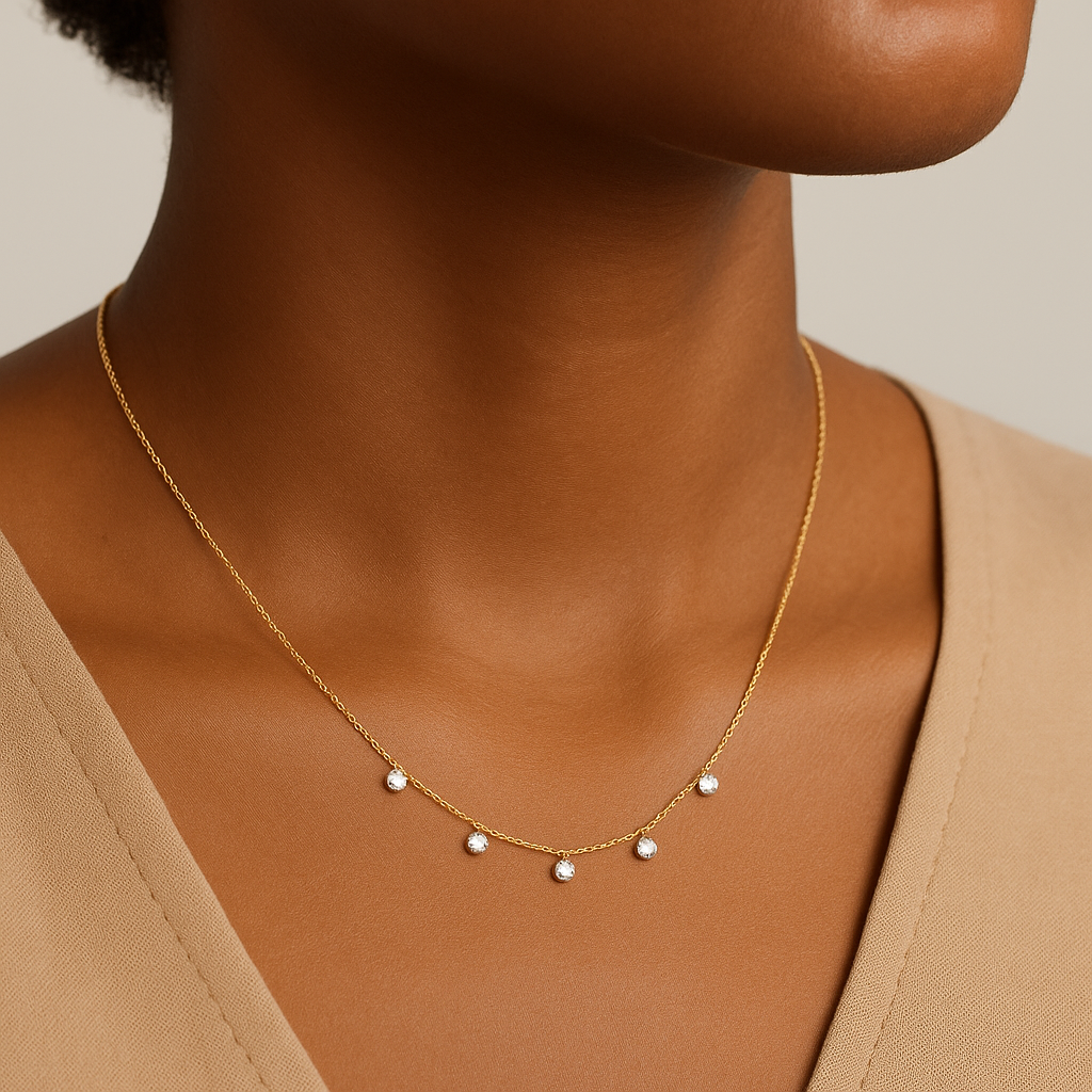 Gold necklace with small pearls on a neutral background