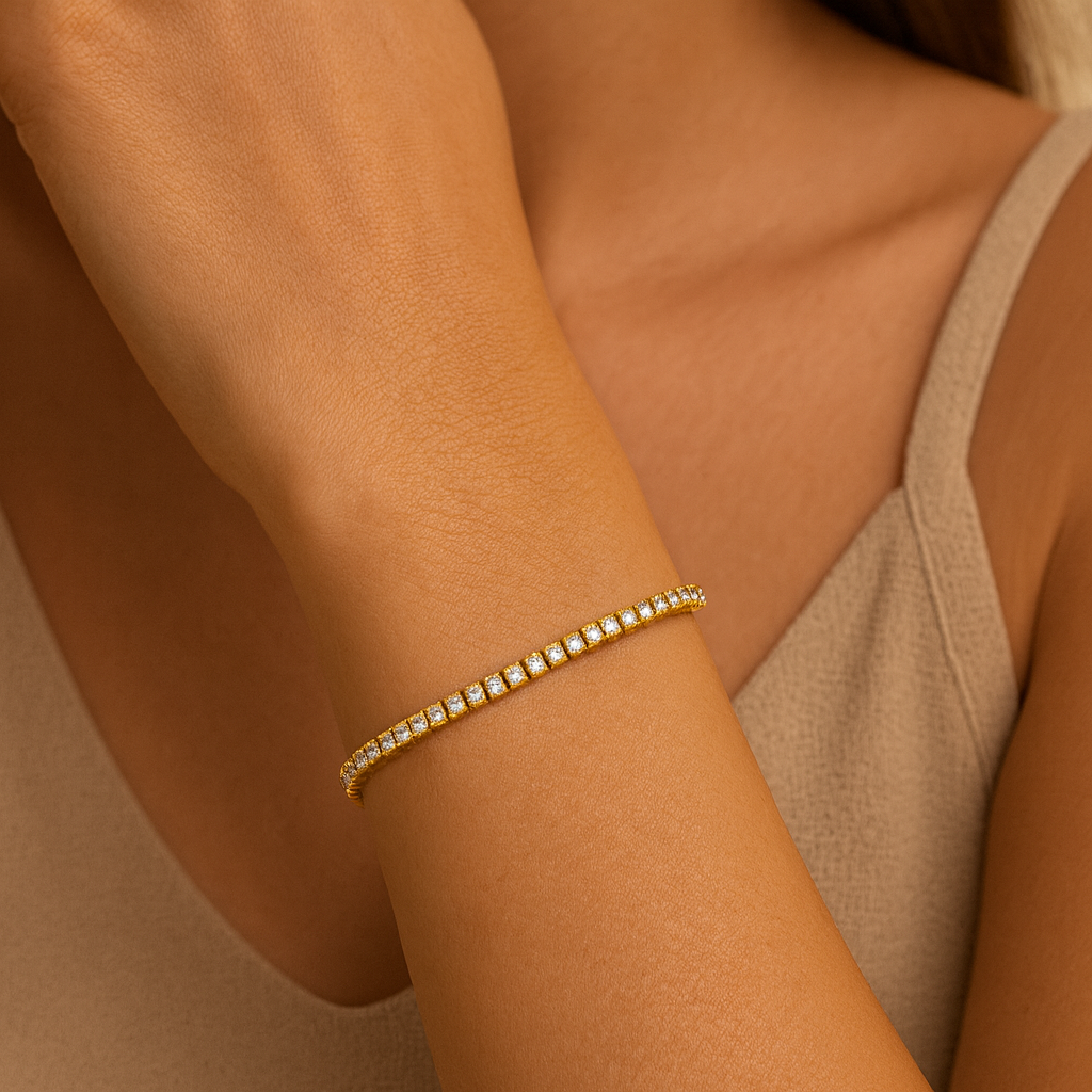 Gold bracelet with diamonds on a wrist against a neutral background