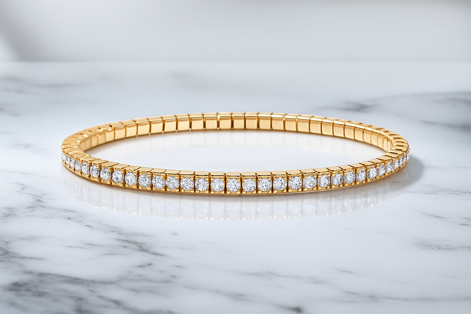 Gold bracelet with diamonds on a marble surface