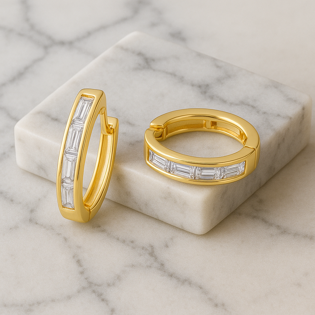 Gold hoop earrings with diamond accents on a marble surface