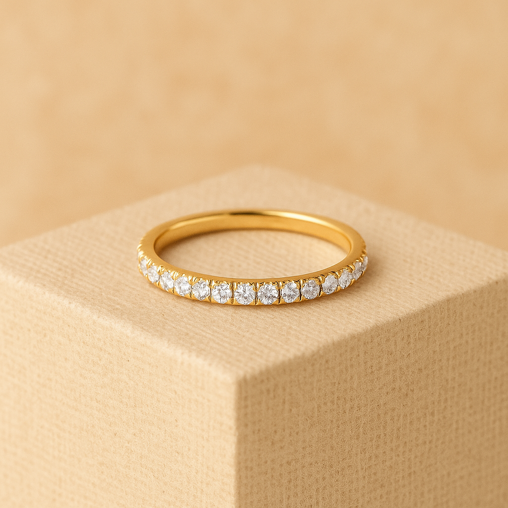 Gold ring with diamonds on a beige cube