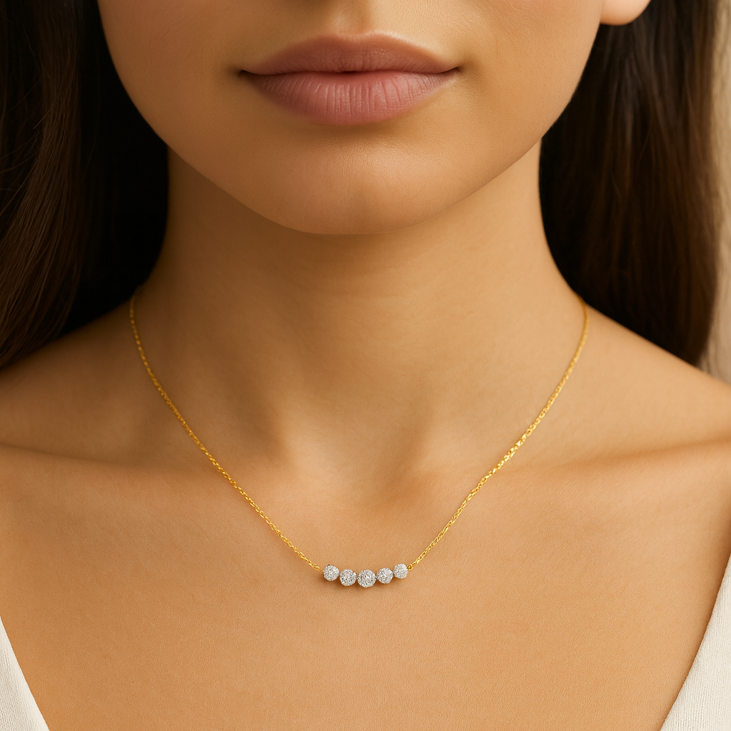 Gold necklace with small diamonds on a model's neck