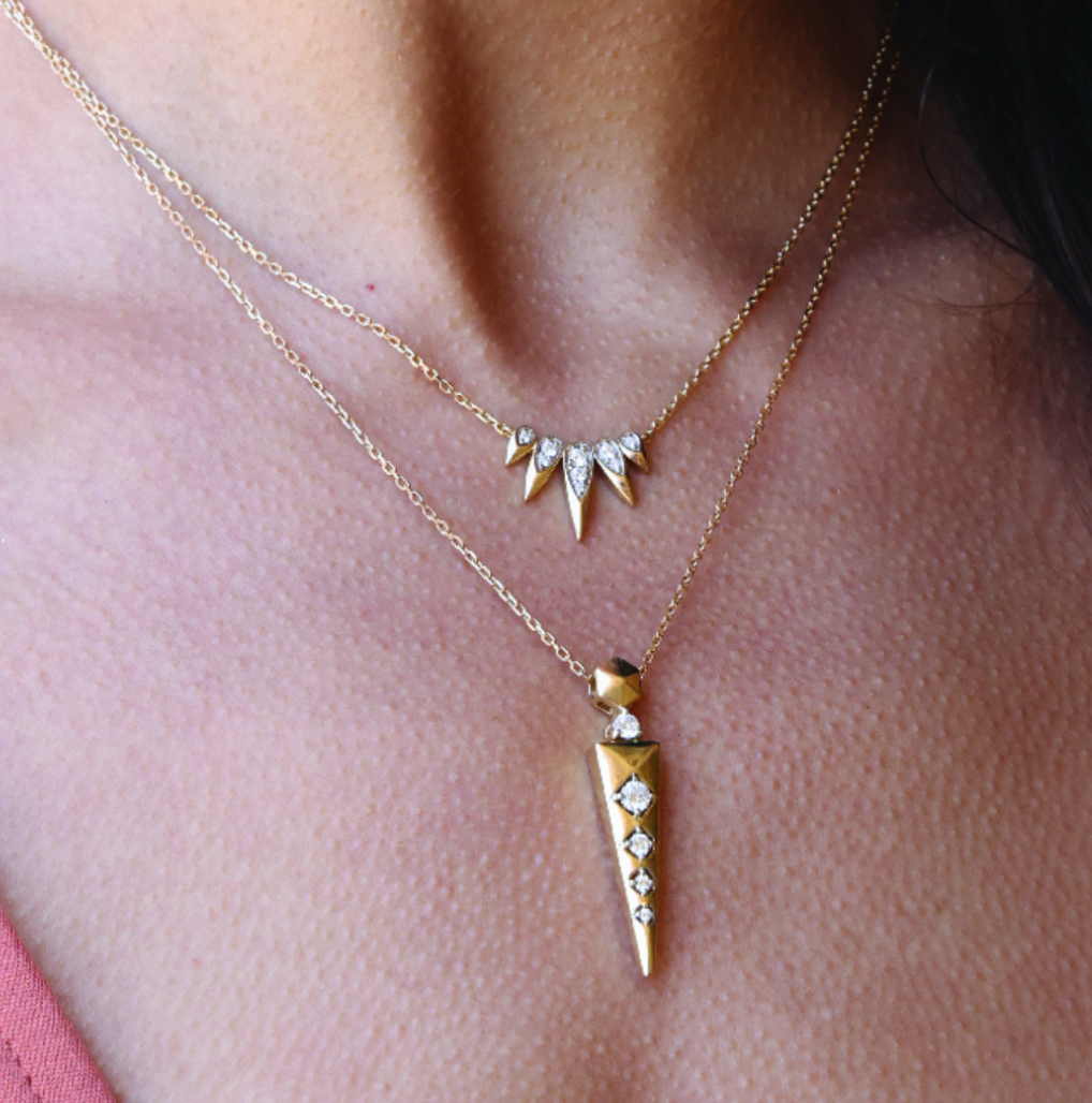 14K solid gold necklaces with diamond pendants on a woman's neck.