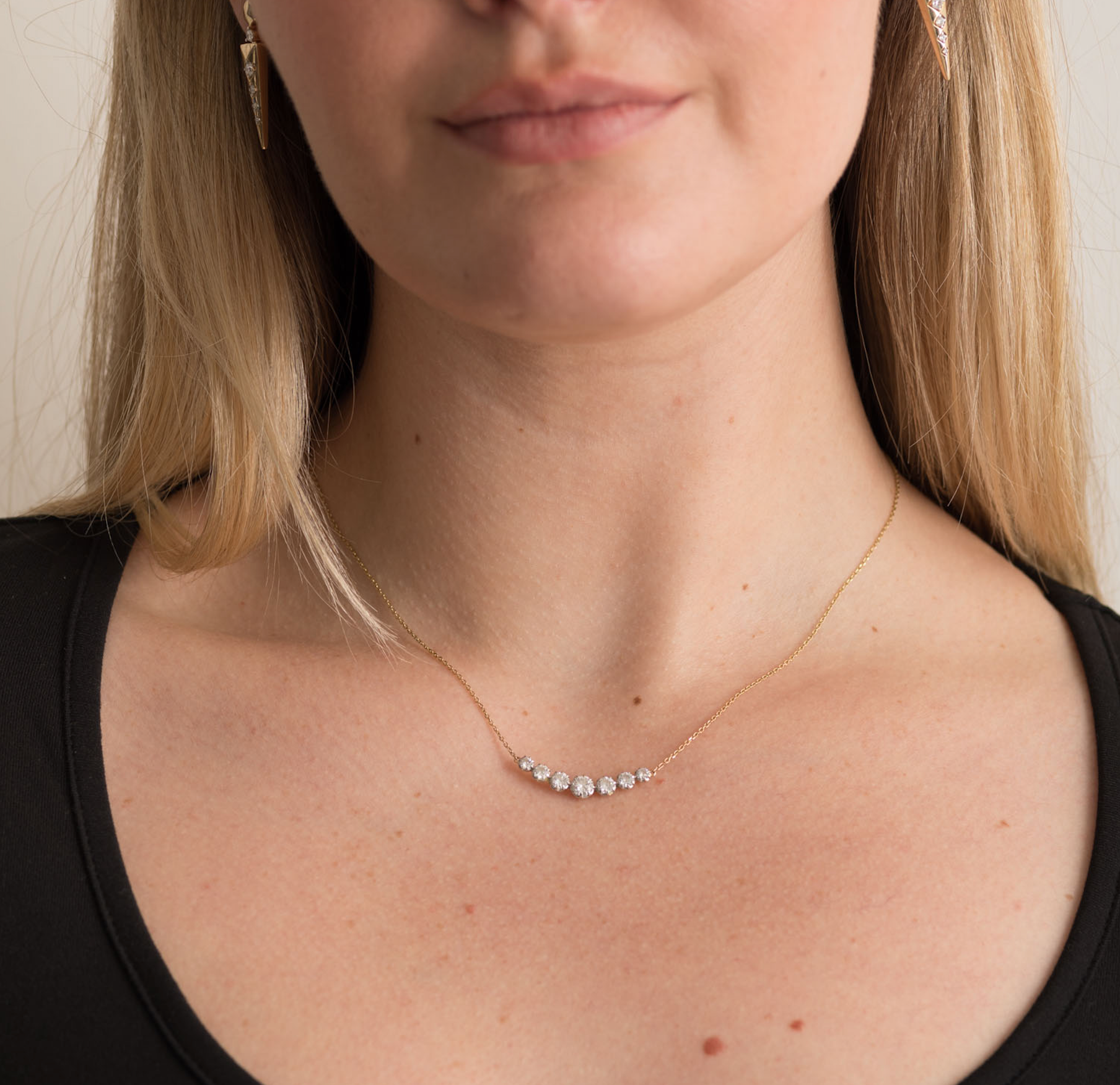 Solid gold necklace with three sparkling diamonds on a delicate chain.