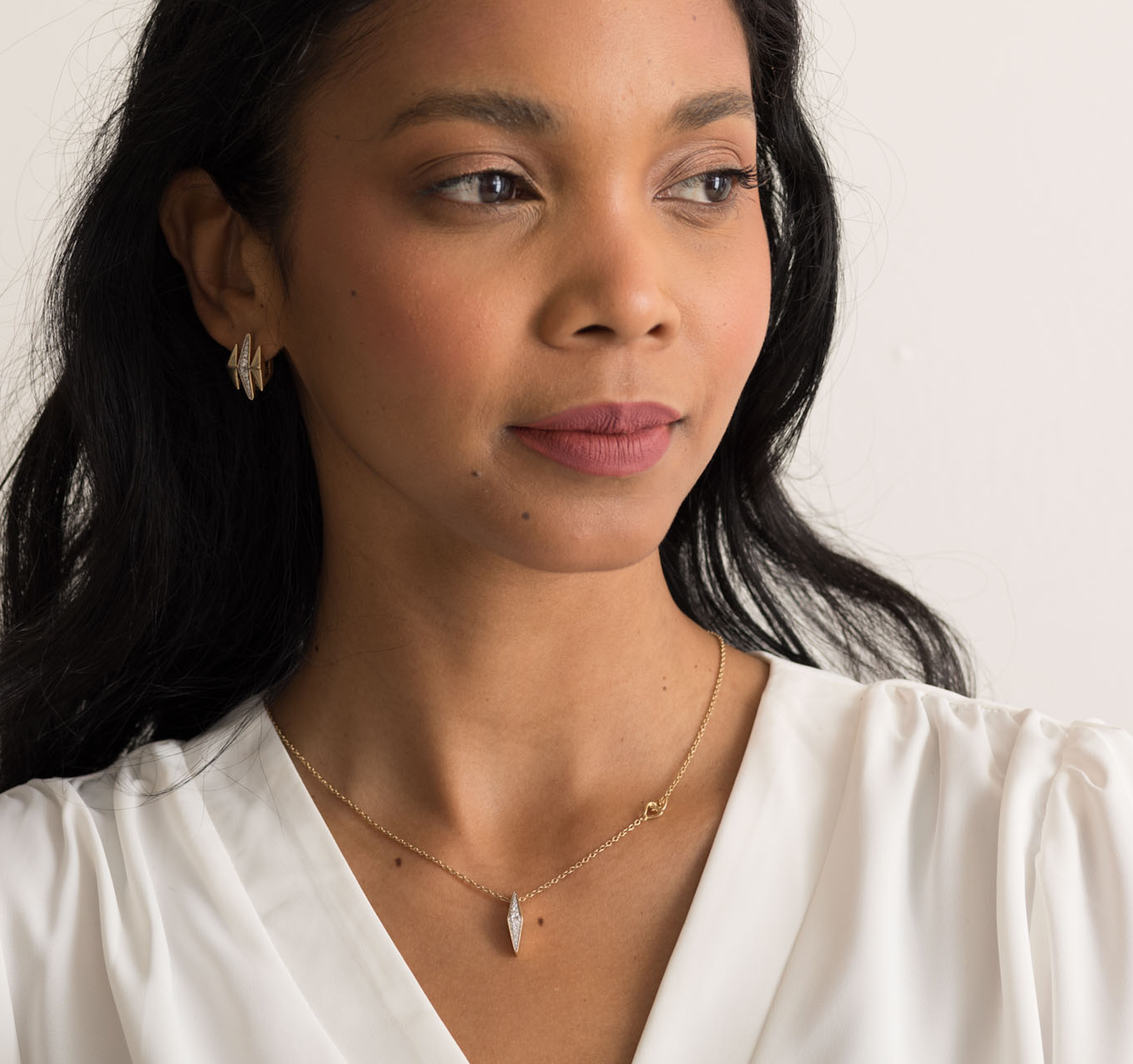 14K solid gold pendant necklace with diamond accents on a delicate chain.