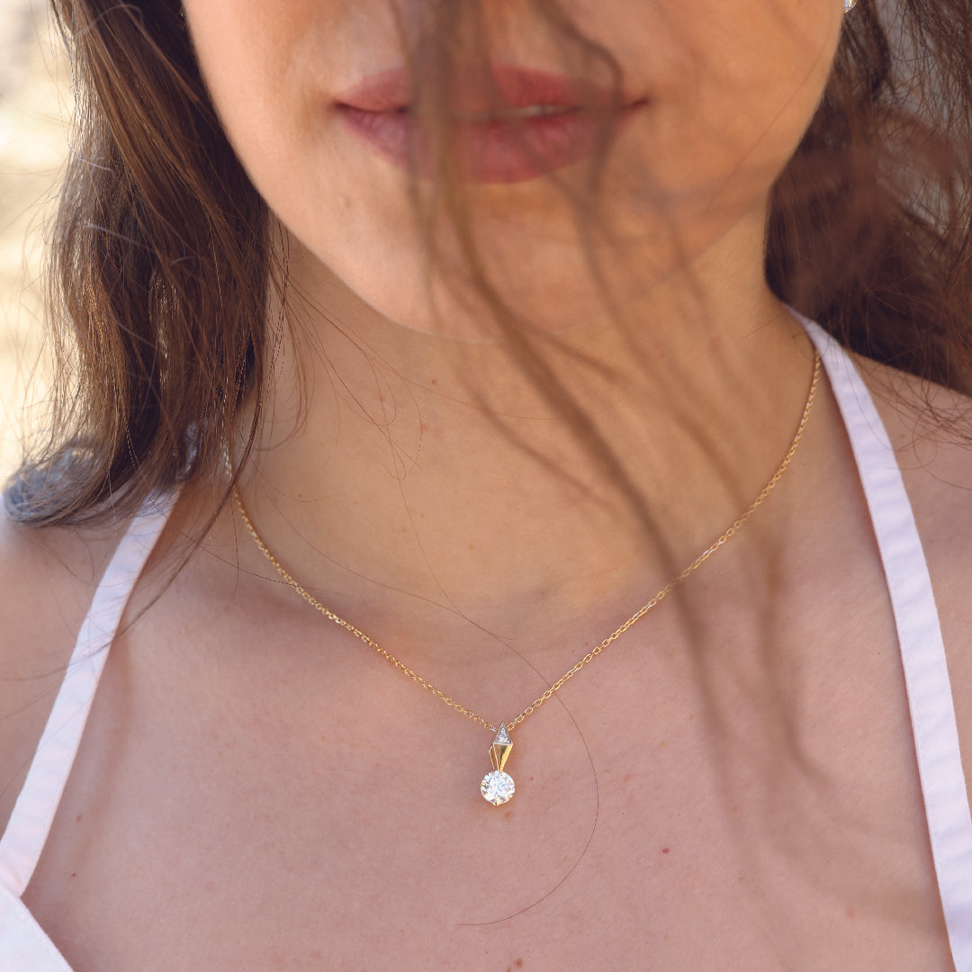 Woman wearing The Harlow 14K solid gold diamond pendant necklace with delicate chain.