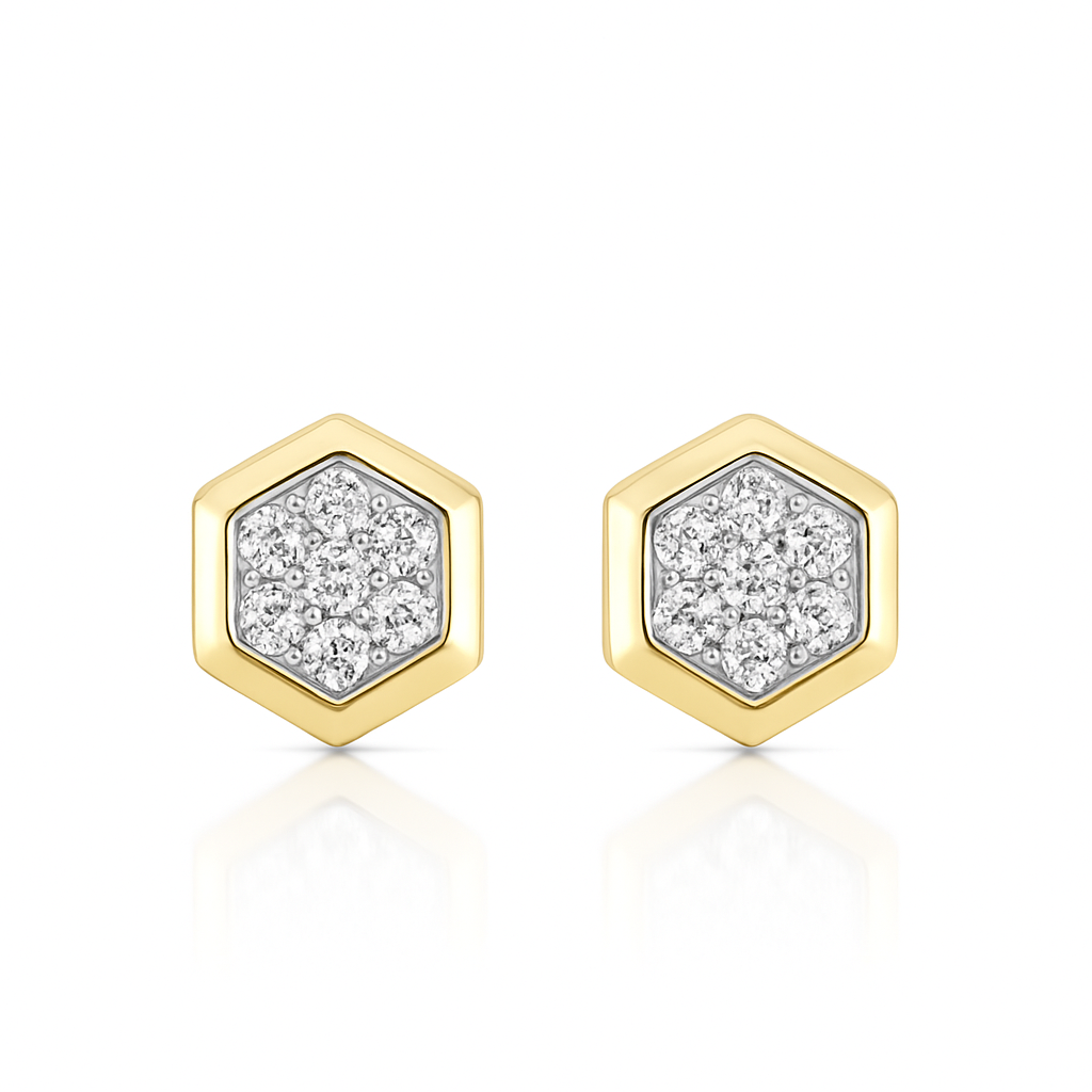 Hexagonal gold earrings with diamond-like material on a white background