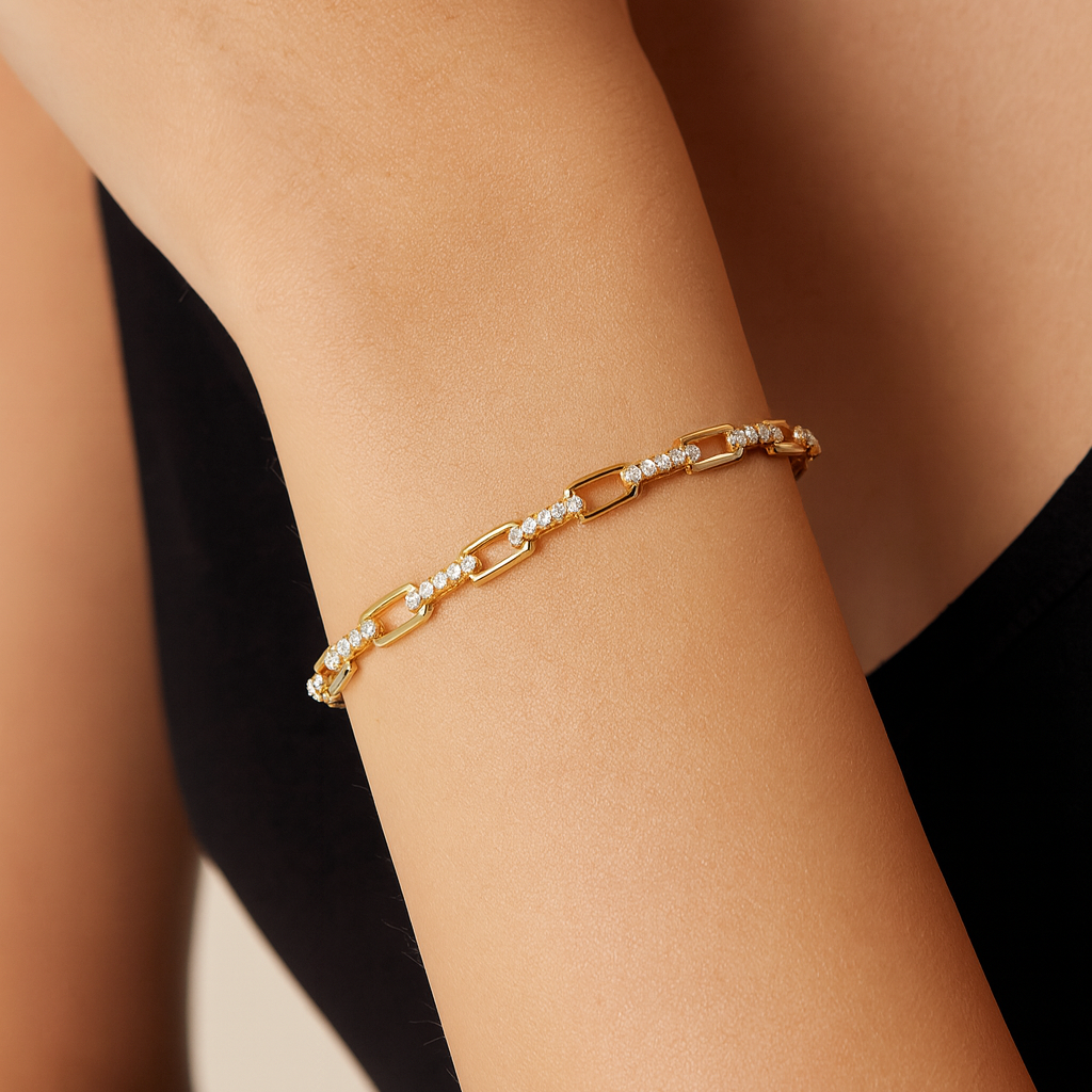 Gold bracelet on a person's wrist with a blurred background