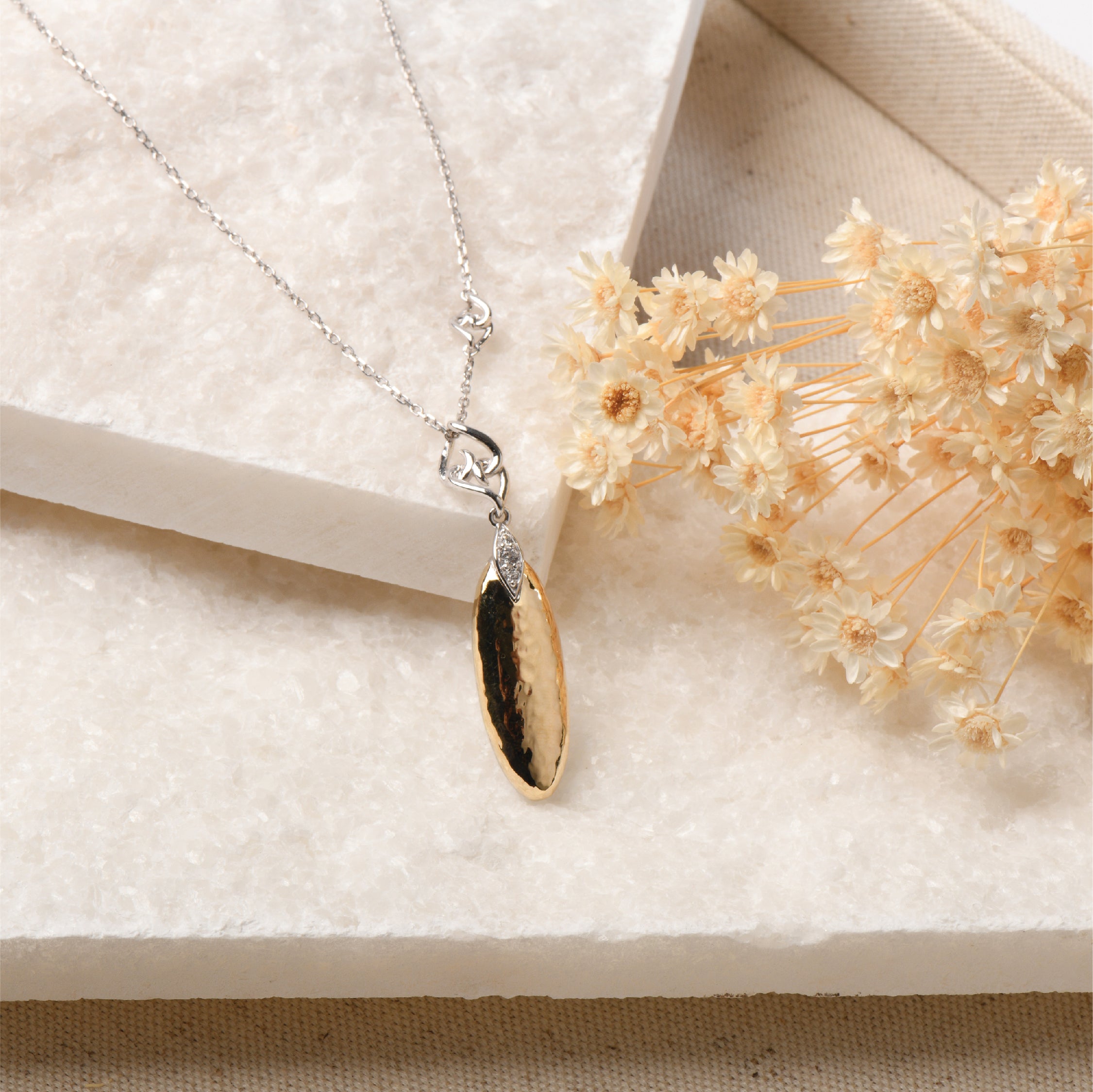 Sterling silver and 14K gold pendant necklace with white sapphires, featuring a teardrop design.