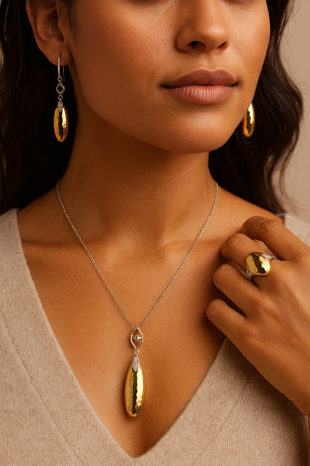 Close-up of a woman wearing gold jewelry including earrings, necklace, and ring.