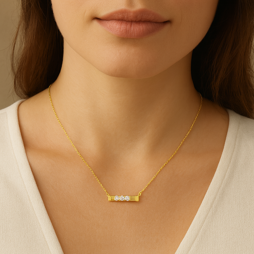 Gold necklace with a bar design featuring three diamonds on a neutral background