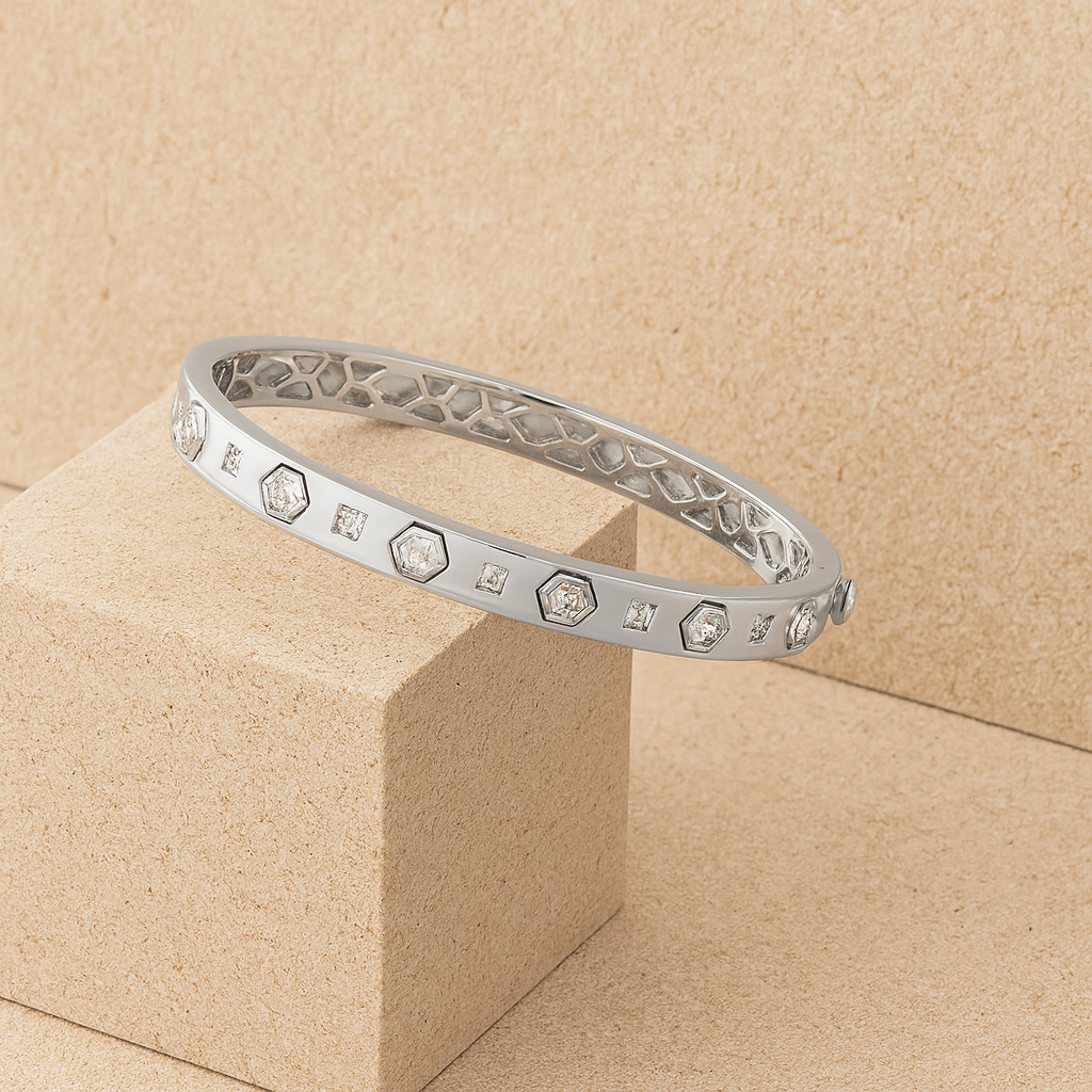 Silver bracelet with diamond accents on a beige background
