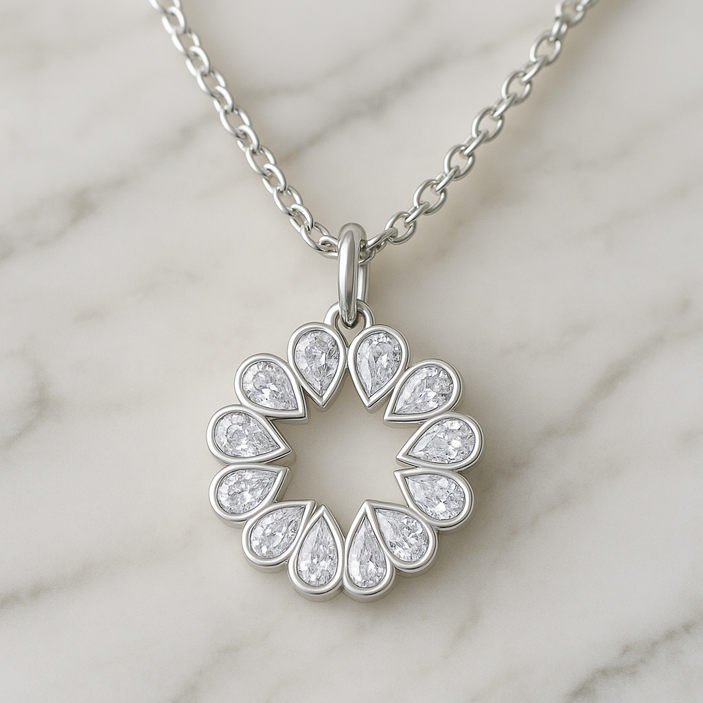 Silver necklace with a circular pendant featuring teardrop-shaped diamonds on a marble surface.