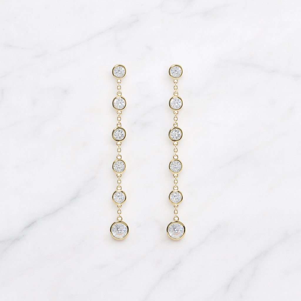 solid gold drop earrings on marble 