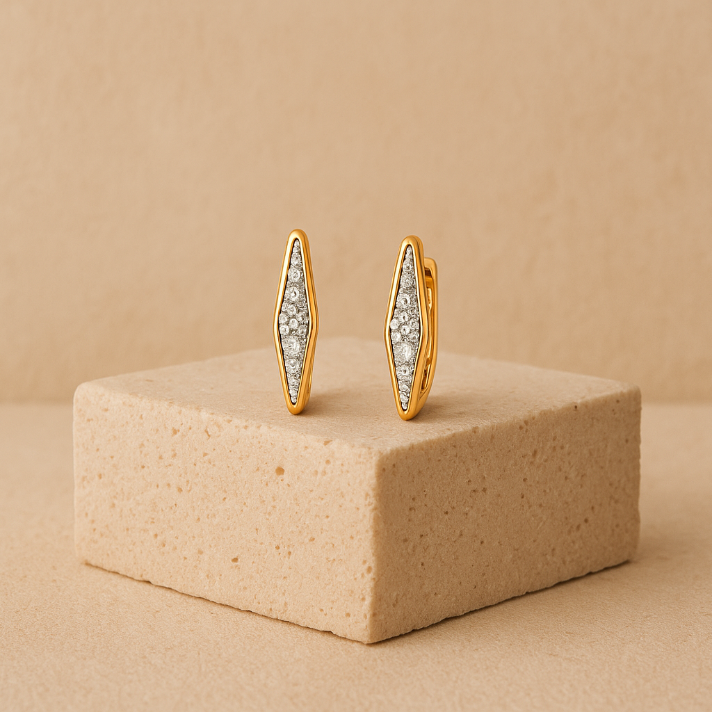 solid gold white lab diamond earrings on a beige brick