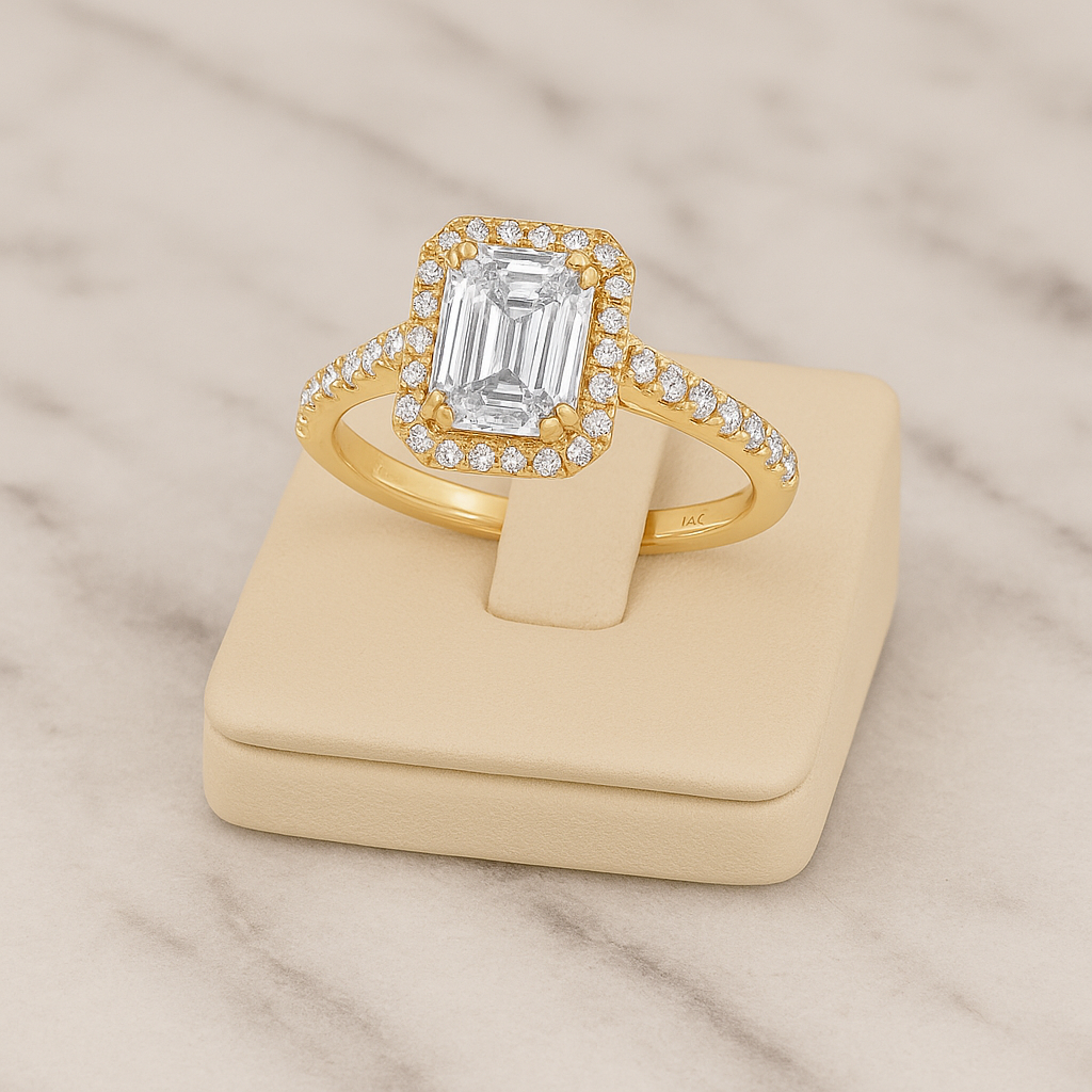 Gold ring with a large diamond on a beige stand against a marble background