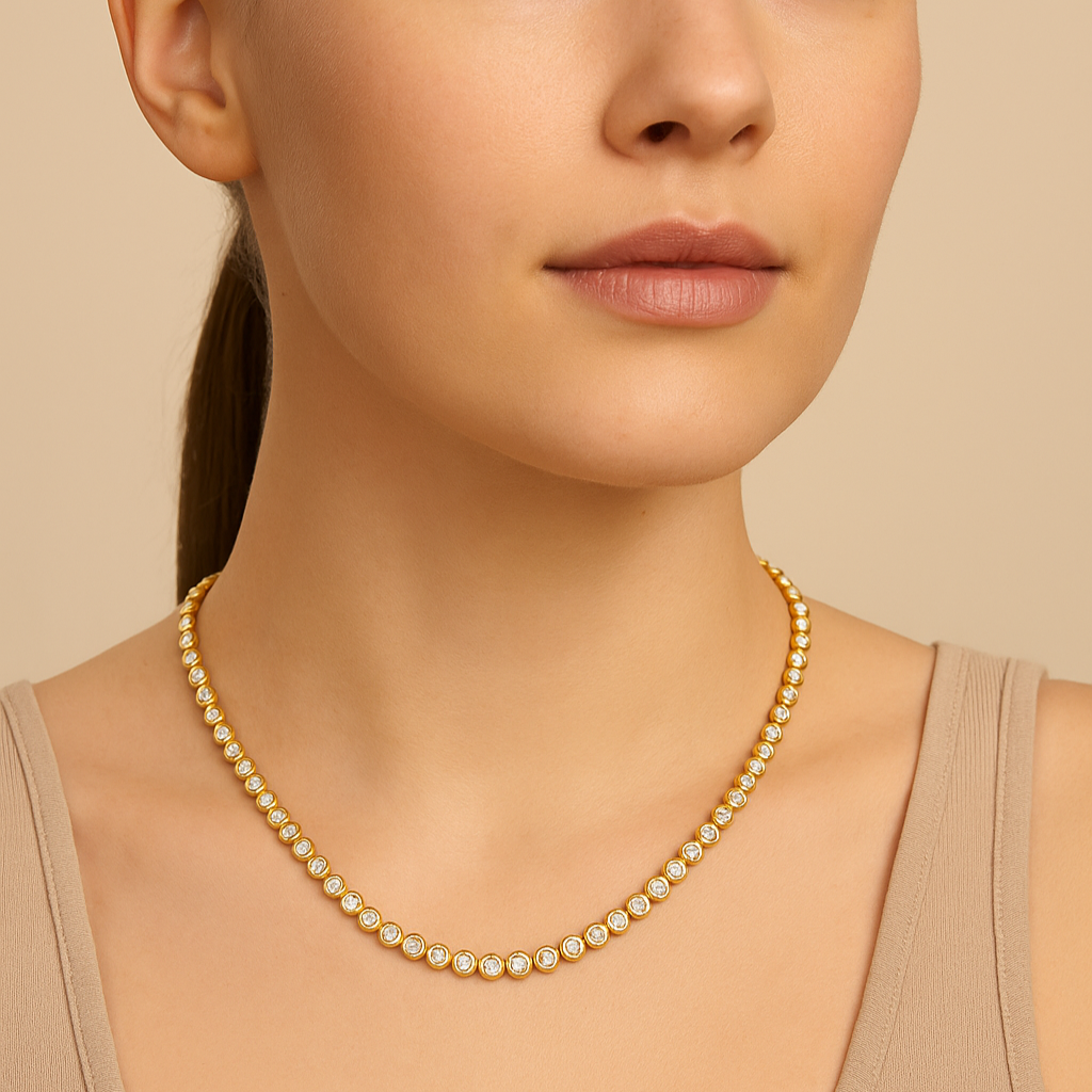 Woman wearing a gold necklace against a beige background