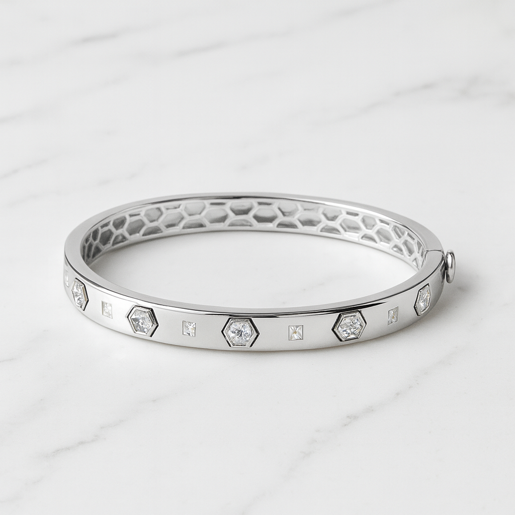 Silver bracelet with diamond accents on a light gray background